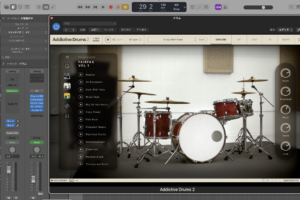Addictive Drums 2 の EXPLORE 画面。キットの写真と、右側に Room / Overhead / Hihat / Snare / Kick のレベルつまみ